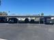 Assigned covered parking area with multiple vehicles parked in designated spots at 3806 Gulf Of Mexico Dr # C205, Longboat Key, FL 34228