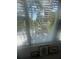A scenic view of lush greenery and sunlight streaming through the window at 3806 Gulf Of Mexico Dr # C205, Longboat Key, FL 34228