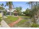 Landscaped backyard with a red brick patio and outdoor seating area, perfect for entertaining guests at 403 29Th Nw St, Bradenton, FL 34205