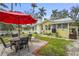 Charming backyard with patio, featuring a dining table, lounge chair, and well-maintained landscaping at 403 29Th Nw St, Bradenton, FL 34205