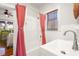 Bathroom features tiled walls, white sink and a window with blinds at 403 29Th Nw St, Bradenton, FL 34205