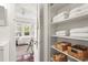 Bathroom storage featuring organized shelves with towels and wicker baskets at 403 29Th Nw St, Bradenton, FL 34205