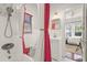 Cozy bathroom boasts white tile, shower and vanity with modern fixtures at 403 29Th Nw St, Bradenton, FL 34205
