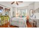 Bright bedroom features wood floors, ceiling fan, and decorative desk and chair at 403 29Th Nw St, Bradenton, FL 34205