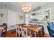 Dining area with a wooden table, chairs, and views into the modern kitchen at 403 29Th Nw St, Bradenton, FL 34205