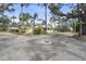 Charming yellow cottage-style home featuring a screened porch and well-maintained landscaping at 403 29Th Nw St, Bradenton, FL 34205