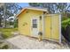 Exterior of detached garage with double yellow doors; gravel landscaping and green lawn at 403 29Th Nw St, Bradenton, FL 34205