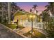Charming cottage with a white picket fence, lush lawn and a beautiful vintage-style lamppost at 403 29Th Nw St, Bradenton, FL 34205