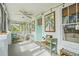 Charming front porch with a ceiling fan, string lights, and seating area at 403 29Th Nw St, Bradenton, FL 34205