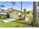 Exterior view of detached garage with double doors, gravel landscaping and green lawn at 403 29Th Nw St, Bradenton, FL 34205