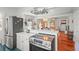 Open kitchen featuring a breakfast bar, stainless steel appliances, and a view of the living space at 403 29Th Nw St, Bradenton, FL 34205