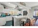 Charming kitchen with white cabinetry, stainless steel appliances, and breakfast bar seating at 403 29Th Nw St, Bradenton, FL 34205