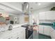 Bright kitchen with white cabinetry, modern appliances, and an open layout to the living space at 403 29Th Nw St, Bradenton, FL 34205