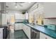 Updated kitchen featuring white cabinets, a stainless steel dishwasher, and a view to another room at 403 29Th Nw St, Bradenton, FL 34205