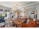 Bright living room featuring a decorative chandelier, hardwood floors, and a cozy fireplace at 403 29Th Nw St, Bradenton, FL 34205