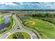 Aerial view of community featuring walking trails, tennis courts, and baseball field, showcasing a great recreational space at 4324 Dairy Ct, Lakewood Ranch, FL 34211