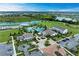 Community aerial view showcasing a pool, clubhouse, and verdant surroundings by a scenic lake at 4324 Dairy Ct, Lakewood Ranch, FL 34211