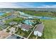 Aerial view of the community pool and recreational area surrounded by lush landscaping and a winding waterway at 4324 Dairy Ct, Lakewood Ranch, FL 34211