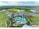Aerial view showcasing the community's resort-style pool, clubhouse, and surrounding green spaces, highlighting its luxurious amenities at 4324 Dairy Ct, Lakewood Ranch, FL 34211