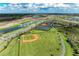 Aerial view featuring baseball field and tennis courts in new community at 4324 Dairy Ct, Lakewood Ranch, FL 34211