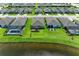 Aerial view of homes with a lake and lush green lawns in a serene neighborhood at 4324 Dairy Ct, Lakewood Ranch, FL 34211