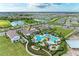 Picturesque aerial view of a community with winding roads, lakes, and a resort-style pool at 4324 Dairy Ct, Lakewood Ranch, FL 34211
