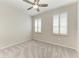 Inviting bedroom featuring plantation shutters, carpeted floors, and ceiling fan at 4324 Dairy Ct, Lakewood Ranch, FL 34211
