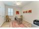Bright bedroom office with modern desk, area rug, plantation shutters and contemporary artwork at 4324 Dairy Ct, Lakewood Ranch, FL 34211