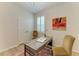 Cozy bedroom office space featuring a writing desk, chairs, and plantation shutters at 4324 Dairy Ct, Lakewood Ranch, FL 34211