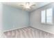 Bright bedroom featuring carpeted floors, ceiling fan, and plantation shutters at 4324 Dairy Ct, Lakewood Ranch, FL 34211