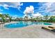Beautiful community pool surrounded by a spacious deck, palm trees, and clear blue skies, offering a resort-like experience at 4324 Dairy Ct, Lakewood Ranch, FL 34211