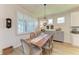 Dining area with wood table, stylish chairs, and modern light fixture at 4324 Dairy Ct, Lakewood Ranch, FL 34211
