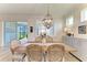 Bright dining area with lake view, wooden table, and stylish light fixture at 4324 Dairy Ct, Lakewood Ranch, FL 34211