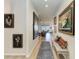 Bright hallway with hardwood floors, stylish art, and comfortable bench seating at 4324 Dairy Ct, Lakewood Ranch, FL 34211