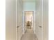 Hallway view into a well-lit room, showcasing neutral carpet and a comfortable chair at 4324 Dairy Ct, Lakewood Ranch, FL 34211
