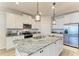 Kitchen featuring white cabinets, granite counters, stainless appliances and pendant lighting at 4324 Dairy Ct, Lakewood Ranch, FL 34211