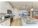 Kitchen featuring white cabinets, granite counters, and stainless appliances at 4324 Dairy Ct, Lakewood Ranch, FL 34211