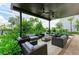 Comfortable outdoor lounge area with stylish seating, ceiling fans, and lush greenery, creating a perfect space for socializing at 4324 Dairy Ct, Lakewood Ranch, FL 34211