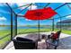 Enclosed patio with stylish furniture overlooks a tranquil lake at 4324 Dairy Ct, Lakewood Ranch, FL 34211
