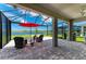 Screened patio featuring brick flooring, comfortable seating, and lake view at 4324 Dairy Ct, Lakewood Ranch, FL 34211