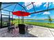 Covered patio with comfortable seating and a view of the serene lake at 4324 Dairy Ct, Lakewood Ranch, FL 34211