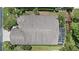 Overhead image of home with screened in lanai, lush landscaping, and a well maintained roof at 4330 Beekman Pl # 103, Sarasota, FL 34235