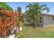 The backyard has a pergola, a large lawn, and a screened-in lanai at 4330 Beekman Pl # 103, Sarasota, FL 34235