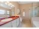 Bathroom features a glass enclosed shower, ample vanity space, and a large mirror at 4330 Beekman Pl # 103, Sarasota, FL 34235