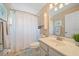 The light-filled bathroom offers a shower, tile floors, and a vanity at 4330 Beekman Pl # 103, Sarasota, FL 34235