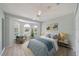 Light-filled bedroom featuring a bay window, a ceiling fan, and neutral decor at 4330 Beekman Pl # 103, Sarasota, FL 34235