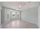 Spacious bedroom featuring a bay window, a ceiling fan, and light wood floors at 4330 Beekman Pl # 103, Sarasota, FL 34235