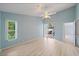 Spacious bedroom with blue walls and a sliding glass door to the pool area at 4330 Beekman Pl # 103, Sarasota, FL 34235
