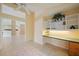This sunny bedroom has tile floors, a ceiling fan, and built-in shelving at 4330 Beekman Pl # 103, Sarasota, FL 34235