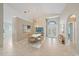 Bright dining room with vaulted ceilings, tile floors, and a modern chandelier at 4330 Beekman Pl # 103, Sarasota, FL 34235